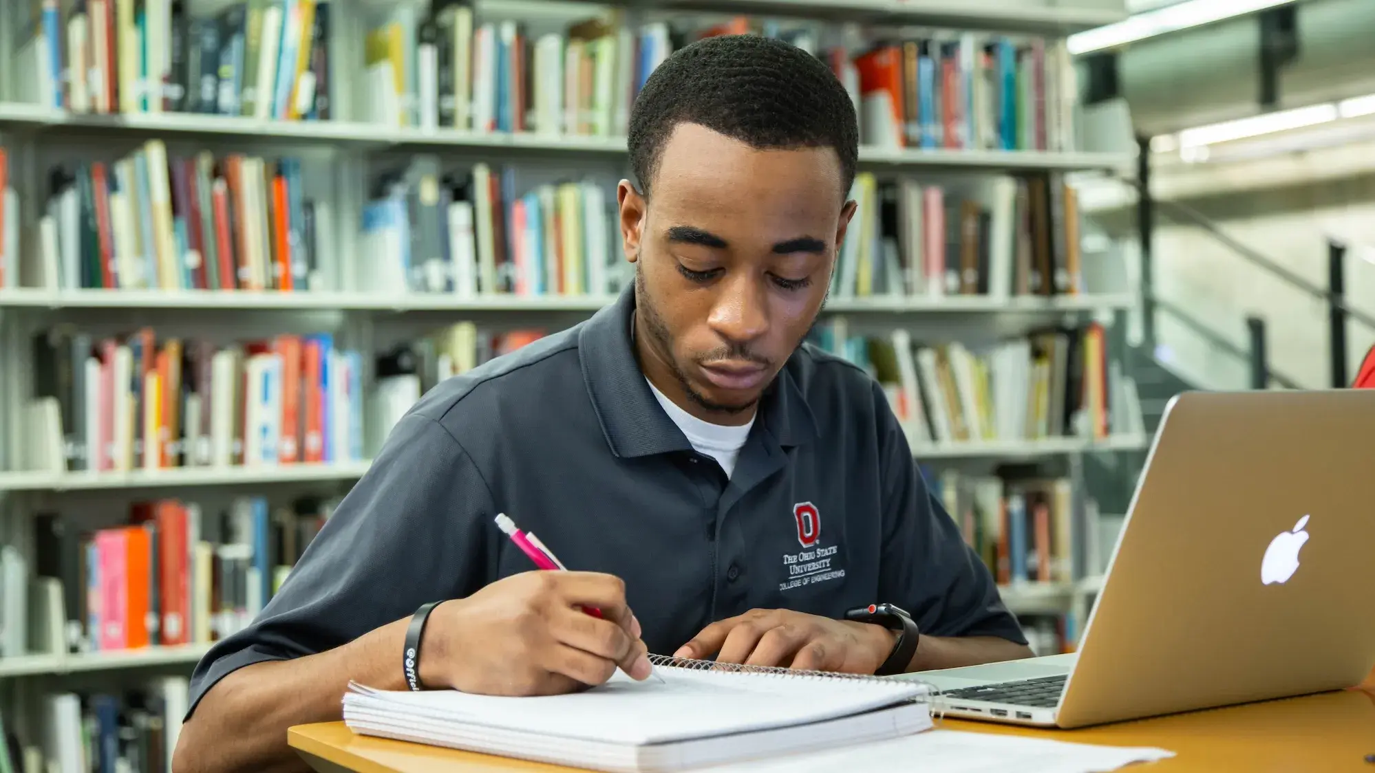 Student using laptop in library