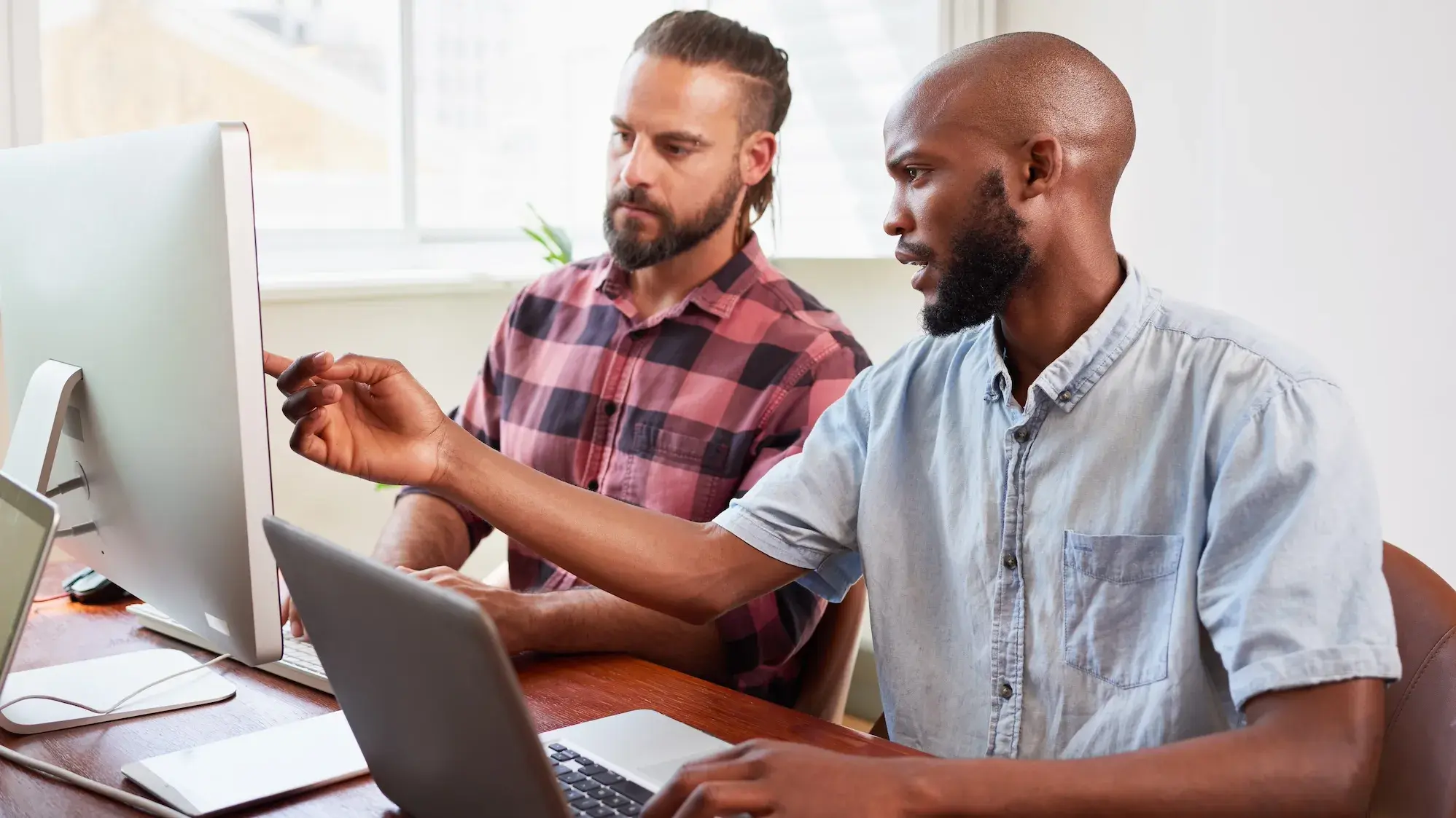 Two people working on a computer