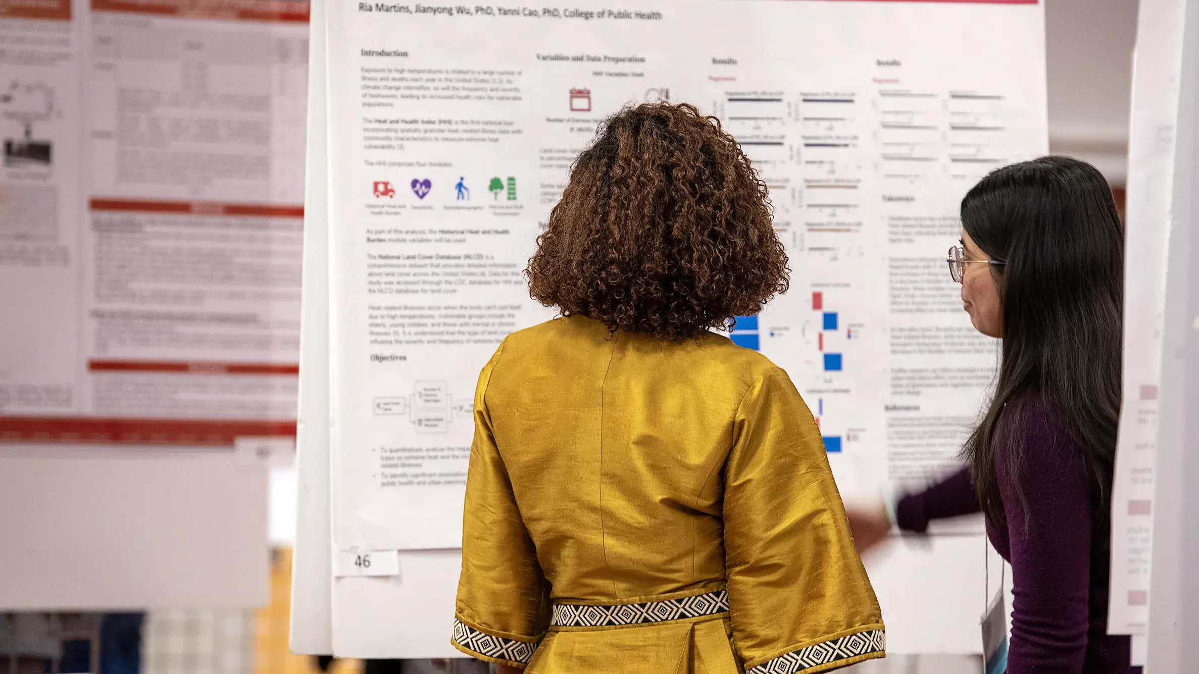 women looking at scientific poster