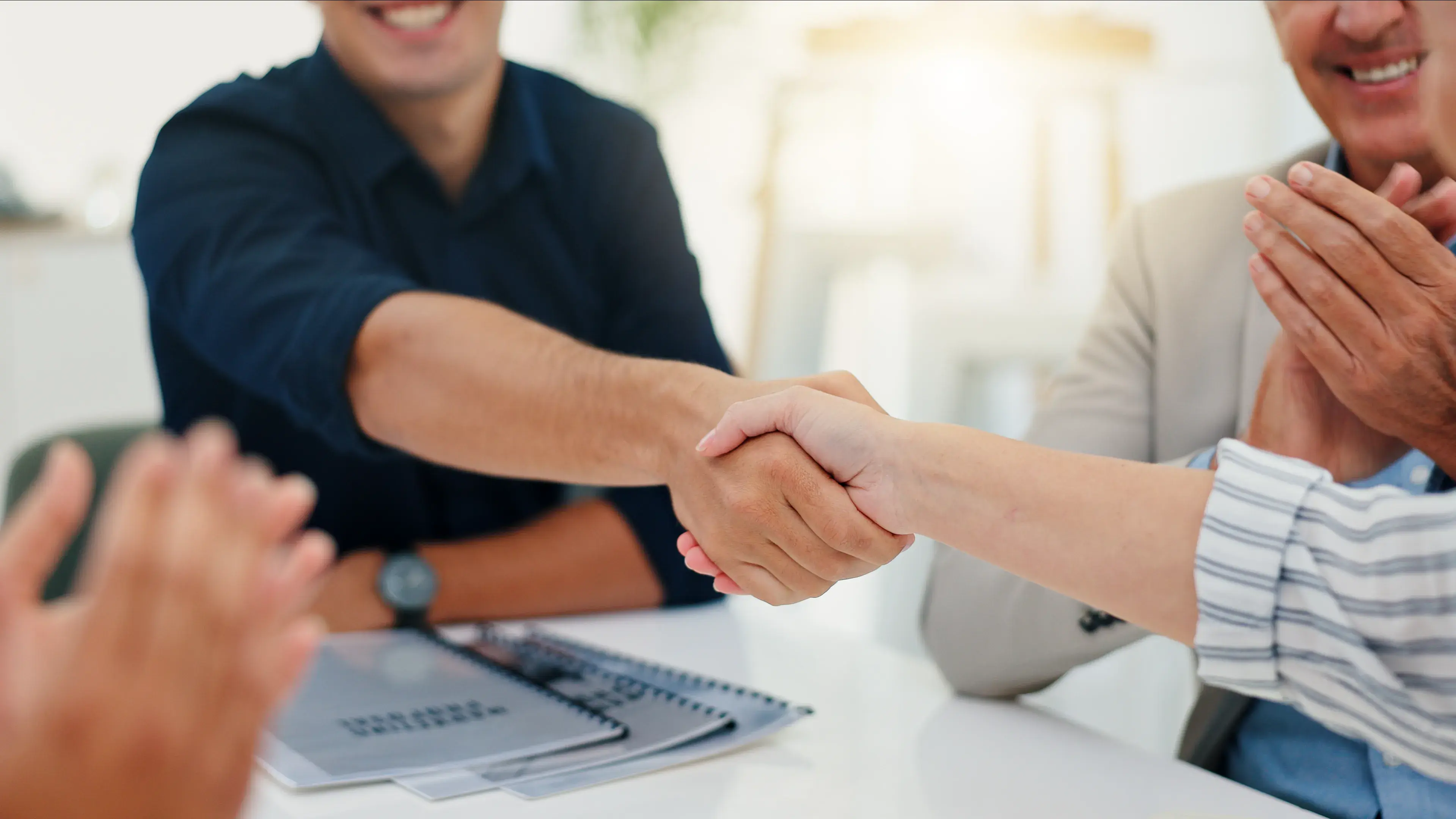 people shaking hands and clapping