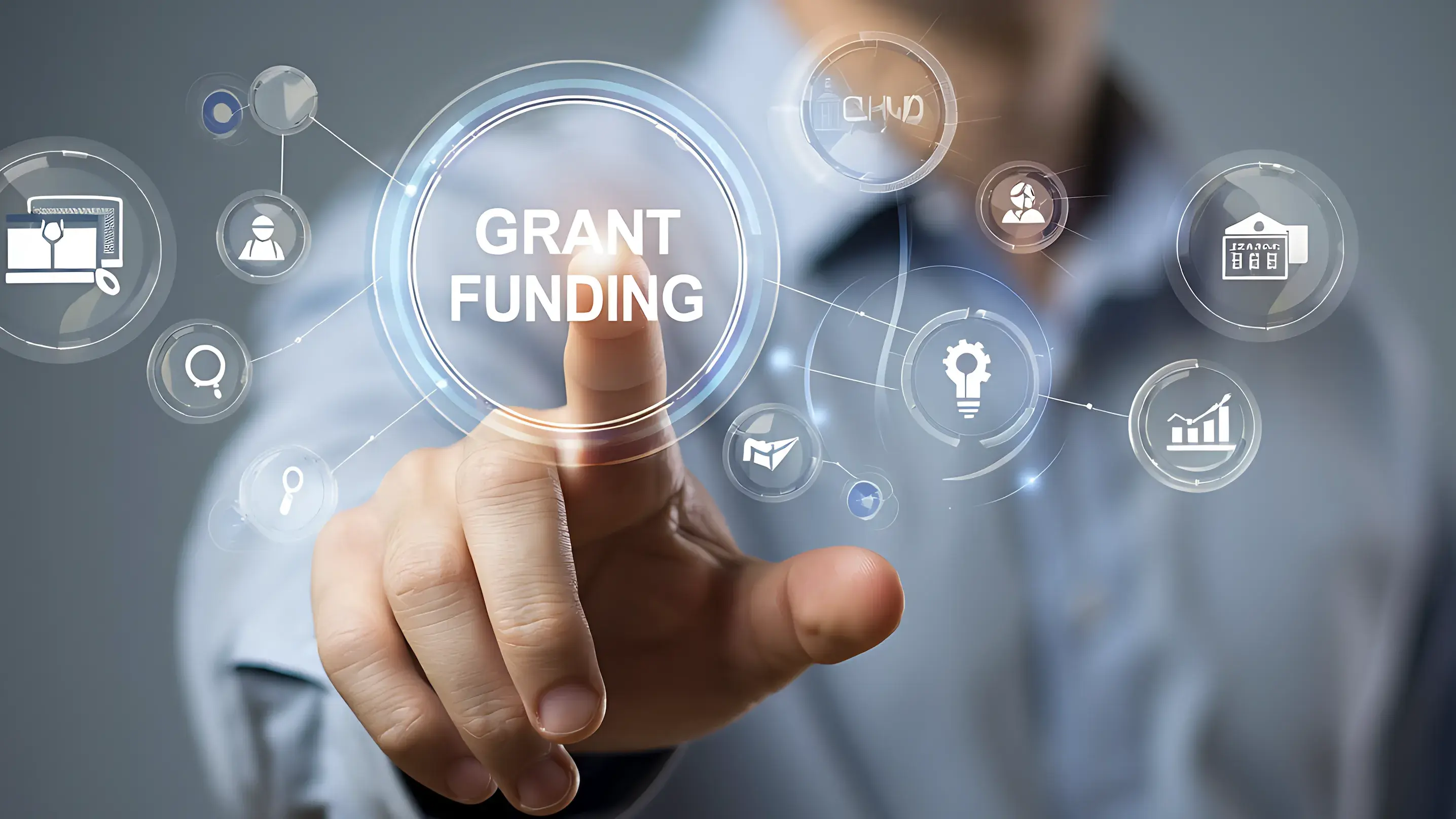 man pressing a grant funding button